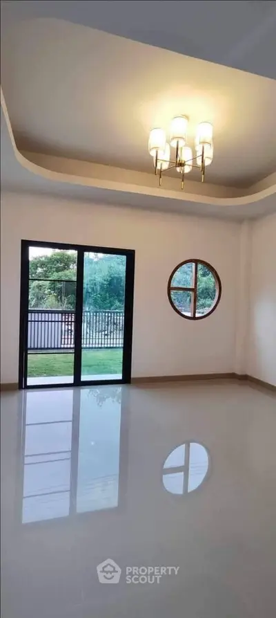 Spacious modern living room with elegant lighting and large windows.