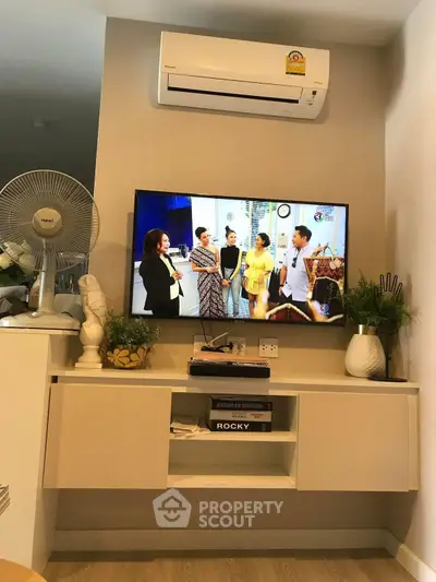 Modern living room with wall-mounted TV and air conditioning unit