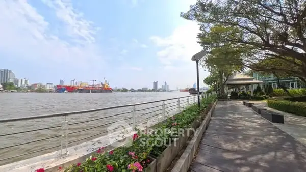 Scenic riverside view with lush greenery and city skyline, perfect for tranquil living.