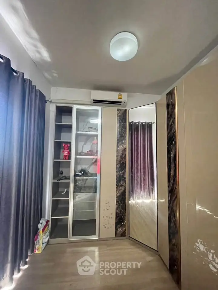 Modern bedroom with sleek wardrobe and air conditioning