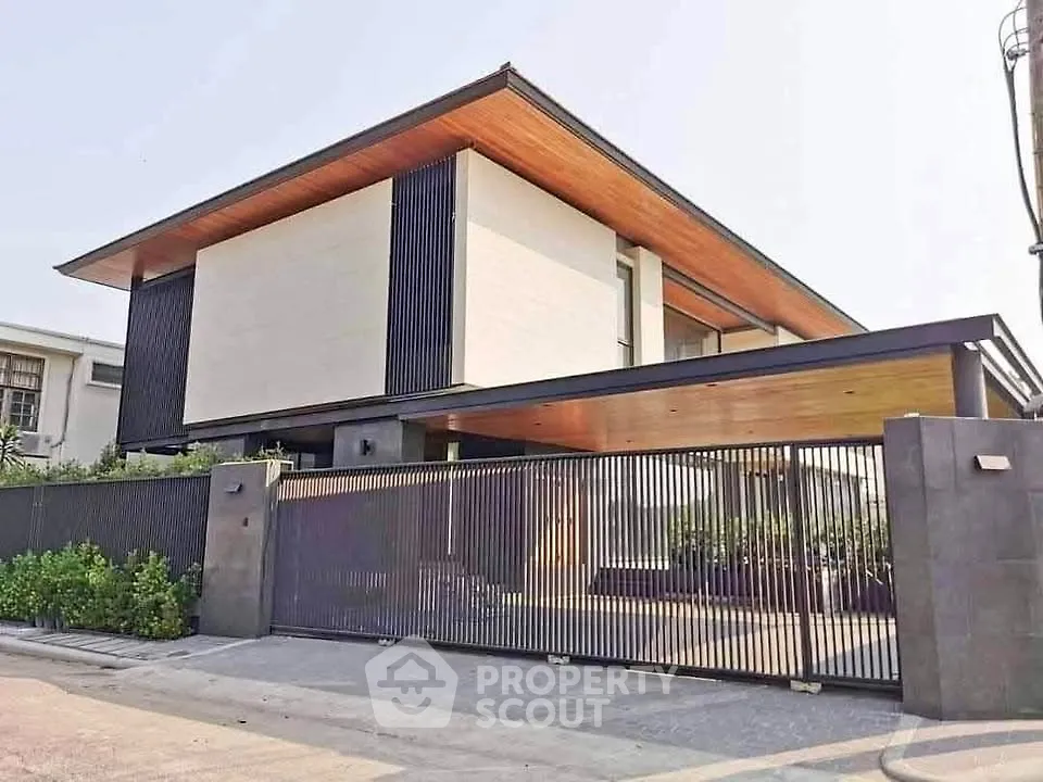 Modern luxury home with sleek design and spacious driveway, featuring a stylish facade and contemporary architecture.