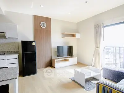 Modern living room with open kitchen and balcony view, featuring sleek furniture and natural light.