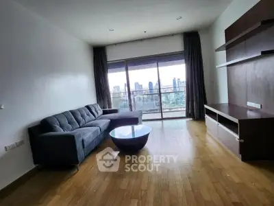 Spacious living room with city view and modern furnishings