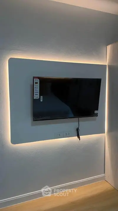 Modern living room with wall-mounted TV and ambient lighting