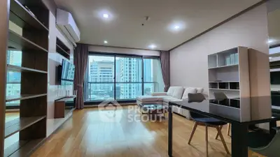 Modern living room with city view, sleek furniture, and wooden flooring