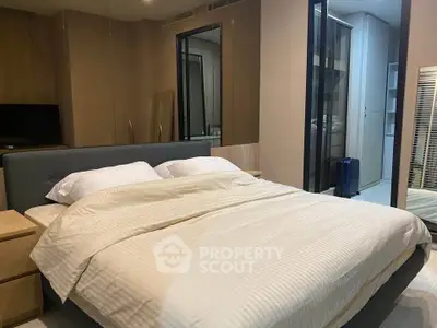Spacious modern bedroom with elegant decor and ample storage space.