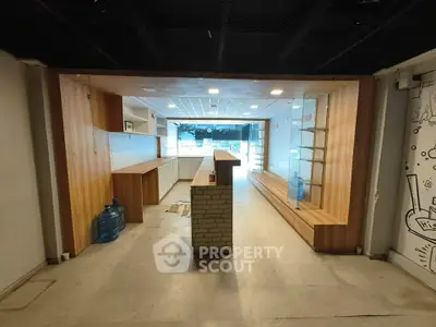 Spacious commercial interior with modern wooden fixtures and ample natural light.