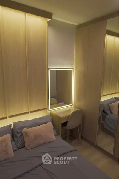 Modern bedroom with stylish lighting and mirrored wardrobe