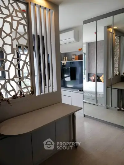 Modern bedroom with mirrored wardrobe and stylish partition in a contemporary apartment.