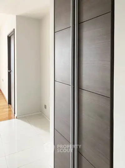 Modern interior hallway with sleek wooden doors and bright flooring