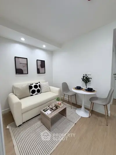 Chic modern living room with cozy sofa and stylish dining area, perfect for urban living.
