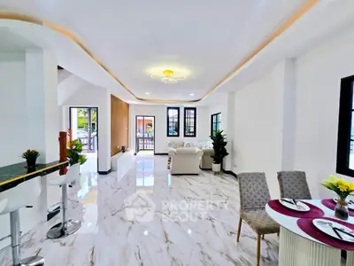Spacious modern living room with elegant marble flooring and stylish furniture, perfect for entertaining.