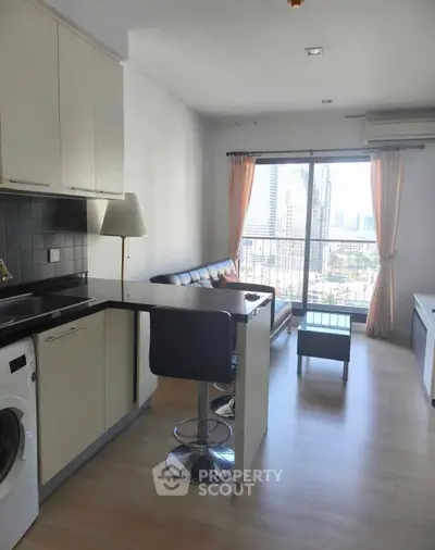 Modern open-layout kitchen with city view and stylish living area