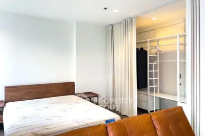 Spacious bedroom with walk-in closet and modern furnishings