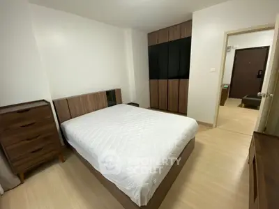 Modern bedroom with sleek wooden furniture and ample storage space