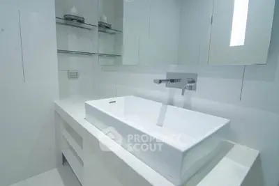 Sleek modern bathroom with elegant white sink and minimalist design.