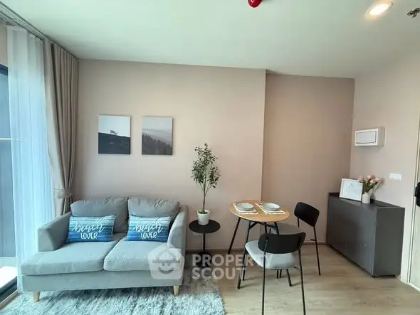 Modern living room with cozy sofa, dining area, and stylish decor in a bright apartment.