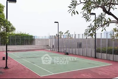 Spacious outdoor tennis court in modern residential complex