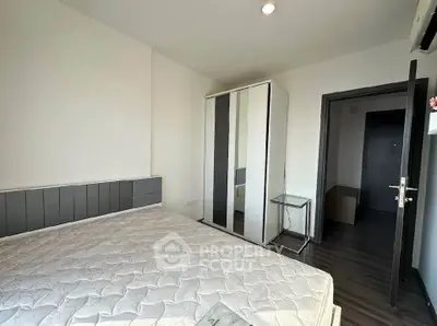 Modern bedroom with sleek wardrobe and comfortable bed in stylish apartment.