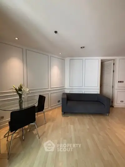 Chic living room with modern furniture and elegant paneling, perfect for urban living.