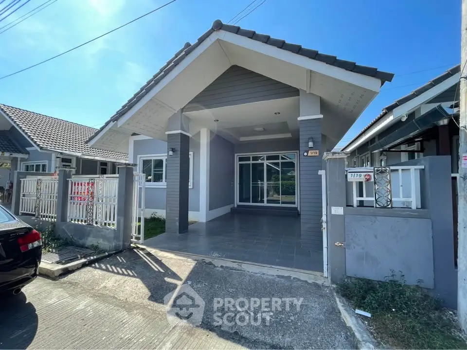 Charming single-story house with modern design and spacious driveway in a serene neighborhood.