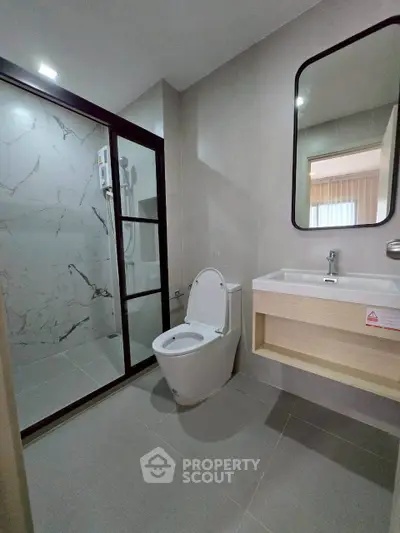 Modern bathroom with sleek shower and elegant fixtures in a contemporary home.