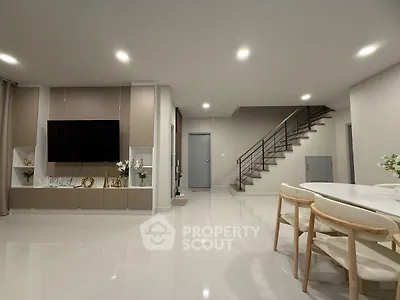 Modern living room with sleek design, open space, and elegant staircase, perfect for contemporary living.
