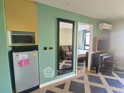 Modern apartment interior with stylish decor, featuring a compact kitchen area and cozy living space.