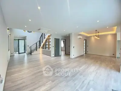 Spacious modern living room with open layout and elegant lighting
