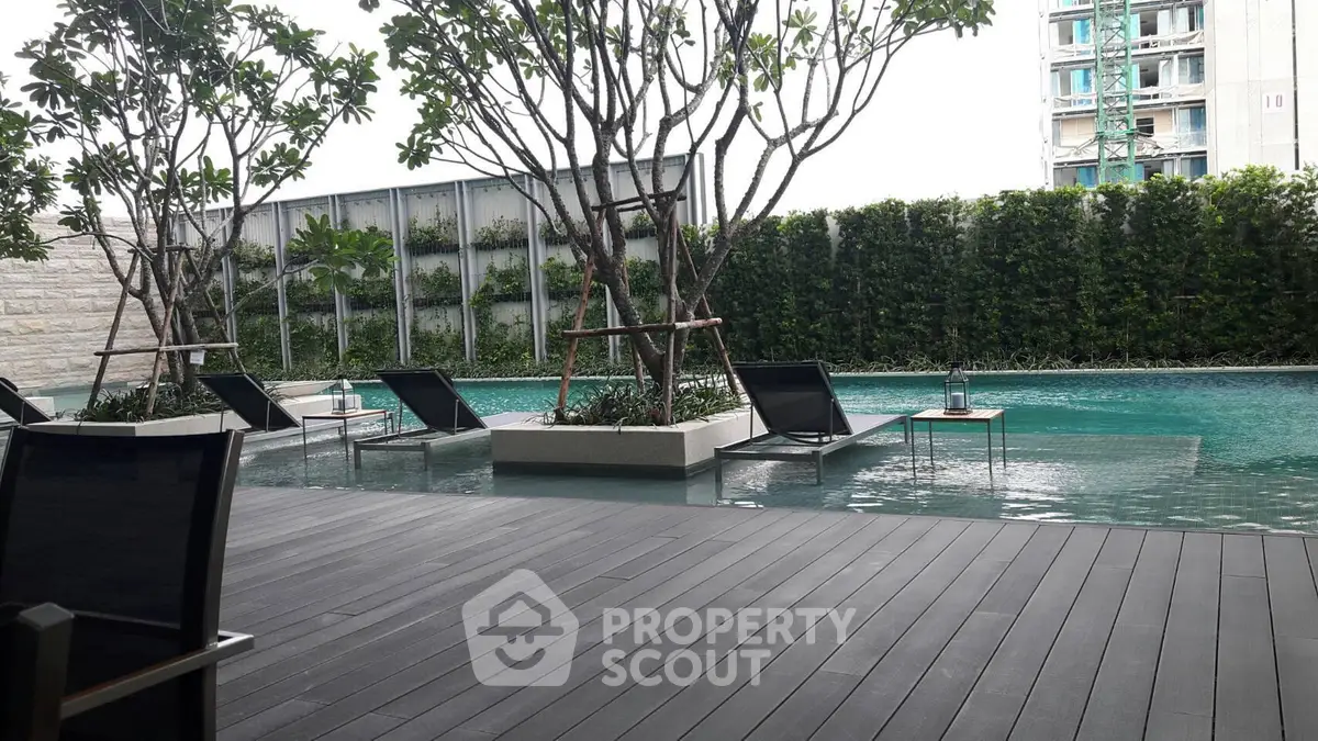 Luxurious outdoor pool area with modern design and lush greenery, perfect for relaxation and leisure.