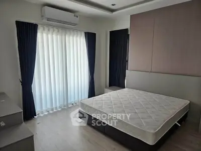 Modern bedroom with large window, air conditioning, and minimalist design.