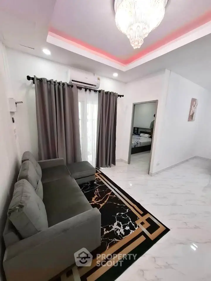 Modern living room with elegant chandelier and stylish marble flooring