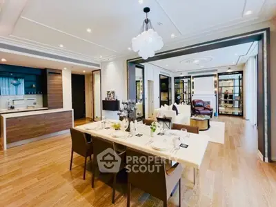 Luxurious open-plan living and dining area with modern kitchen and elegant decor.