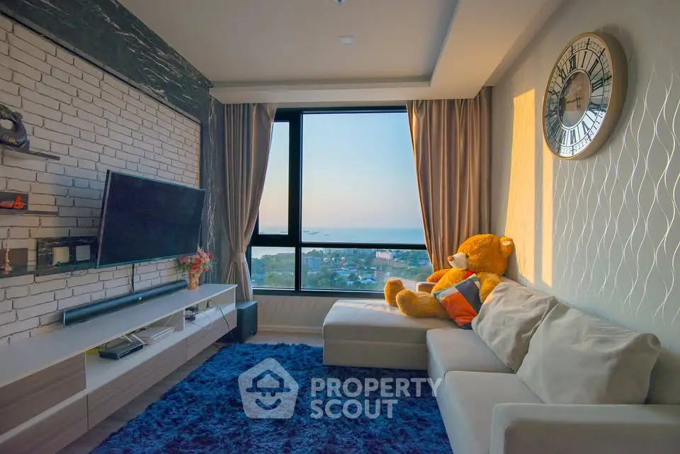 Charming living room with stunning sea view, plush sofa, and elegant decor.