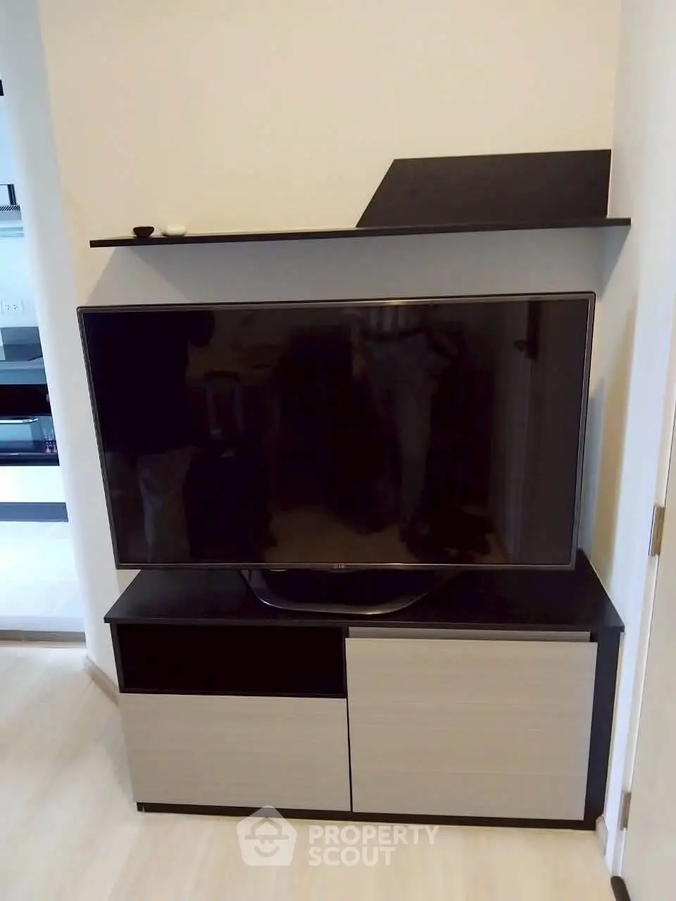 Modern living room with sleek TV stand and mounted flat-screen TV, perfect for entertainment setup.