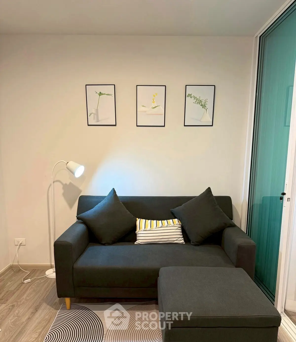 Cozy living room with modern sofa, stylish decor, and soft lighting.