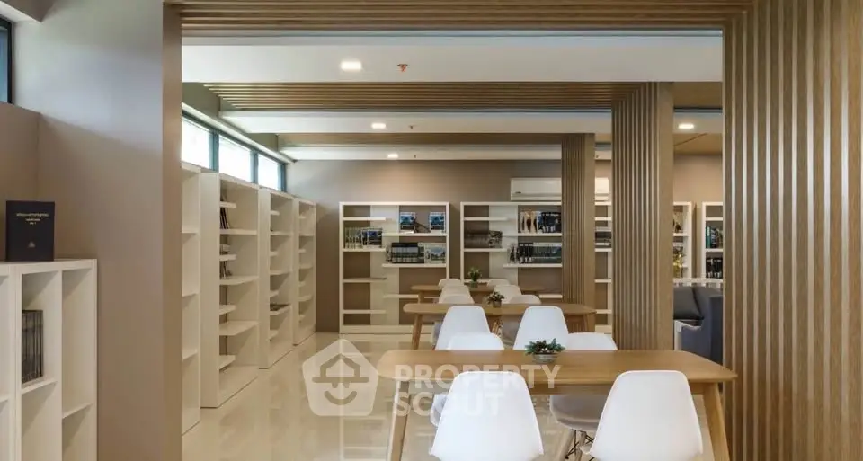 Modern library with sleek wooden accents and white shelving, perfect for study or relaxation.