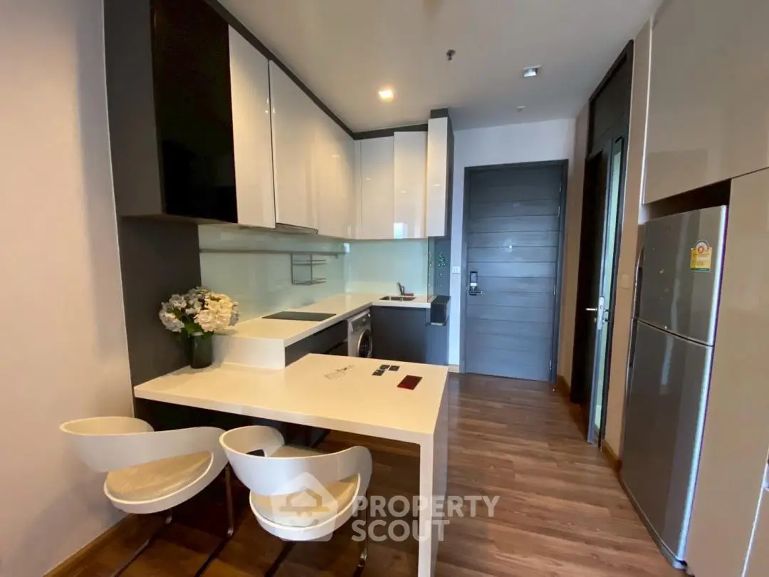 Modern kitchen with sleek cabinets and breakfast bar in stylish apartment