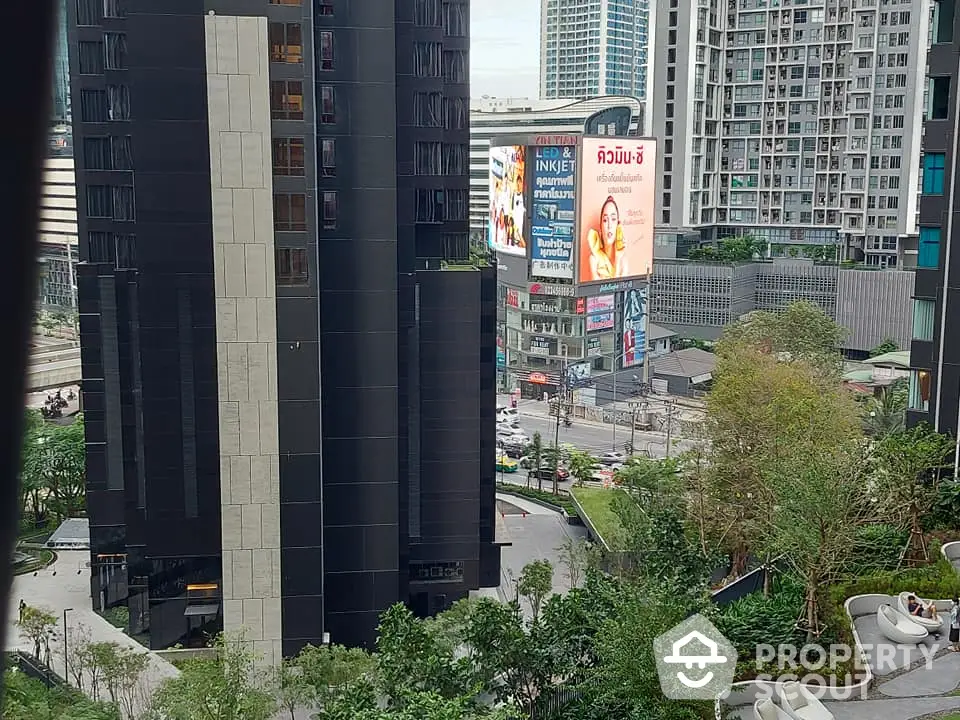 Modern urban apartment buildings with lush greenery and city view