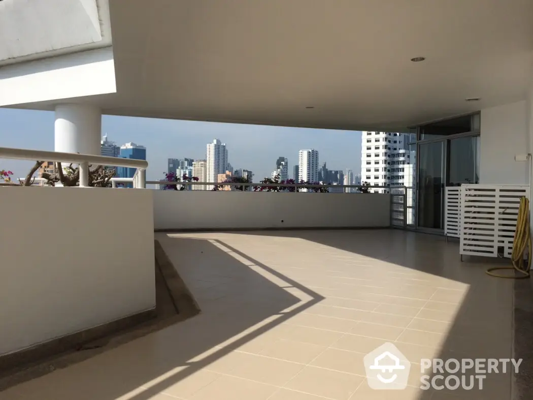 Spacious balcony with city skyline view in modern apartment