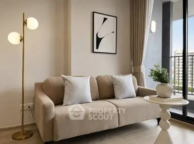 Modern living room with elegant sofa and stylish decor, featuring a large window with city view.