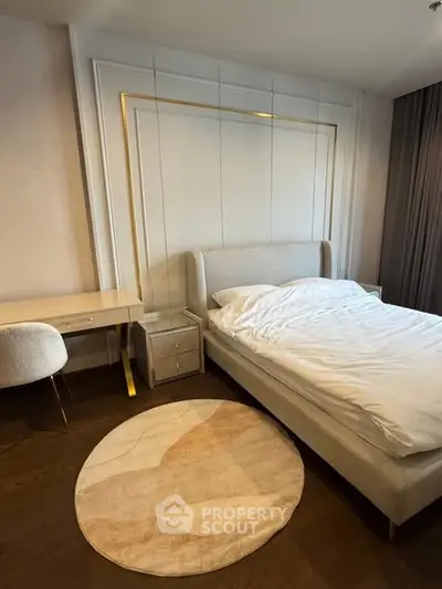 Elegant bedroom with modern decor and cozy ambiance, featuring a stylish bed and chic furniture.