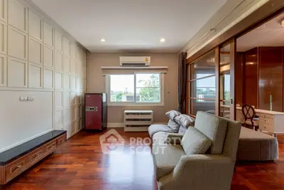 Spacious living room with modern furniture and wooden flooring