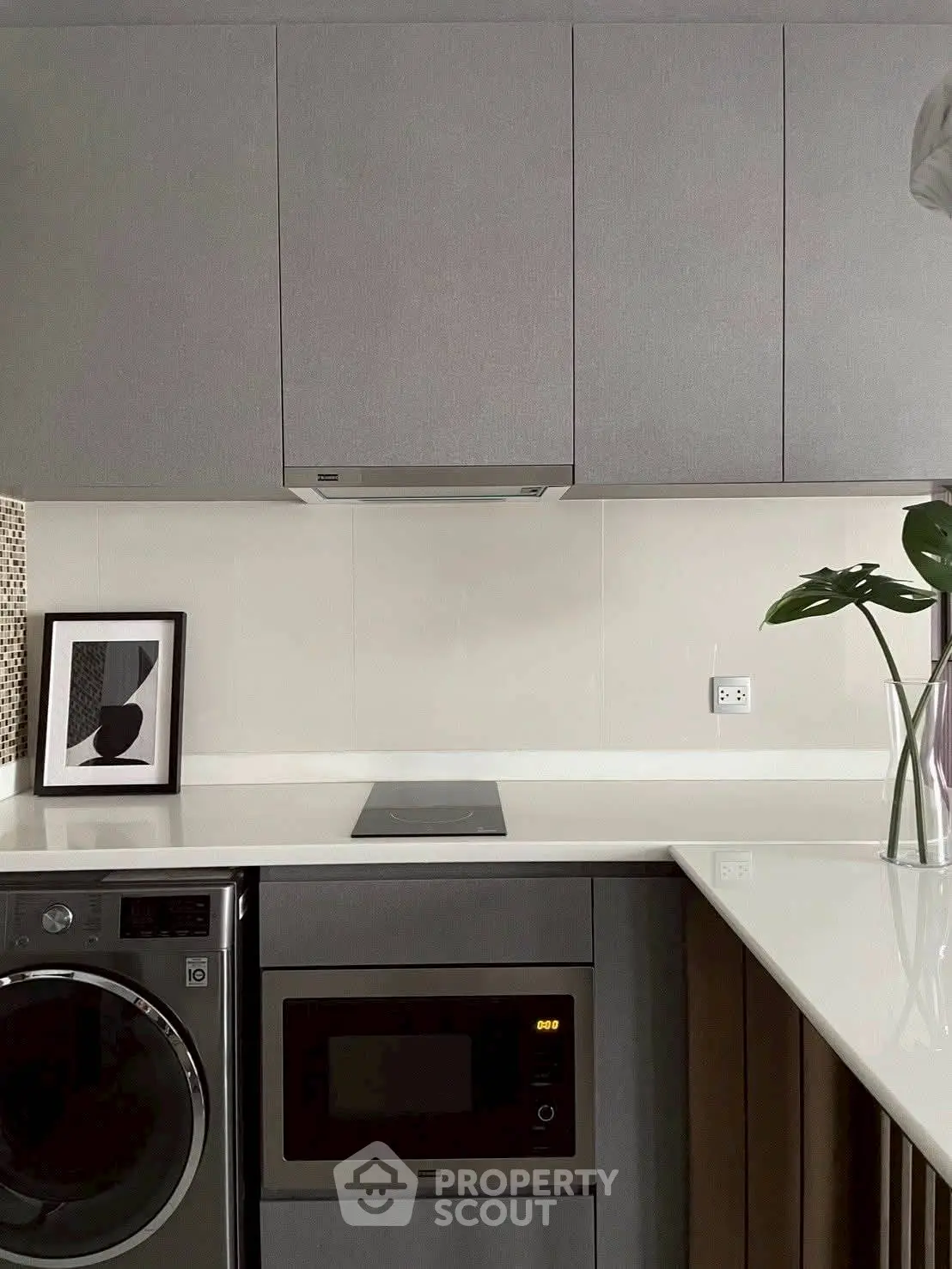 Modern kitchen with sleek cabinetry, built-in appliances, and stylish decor accents.