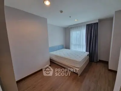 Spacious bedroom with natural light and modern design in prime real estate location.