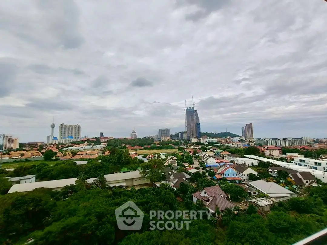 Stunning cityscape view with lush greenery and skyline in the background.