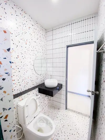 Modern bathroom with terrazzo tiles and sleek fixtures