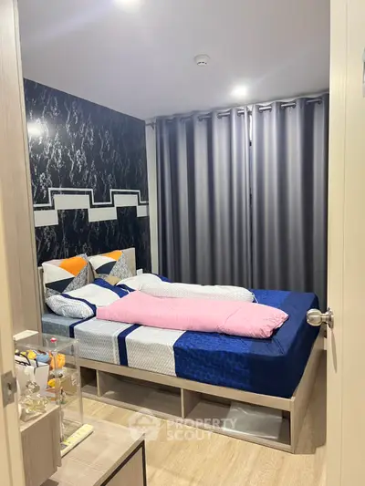 Cozy bedroom with modern decor and stylish bedding in a contemporary apartment.