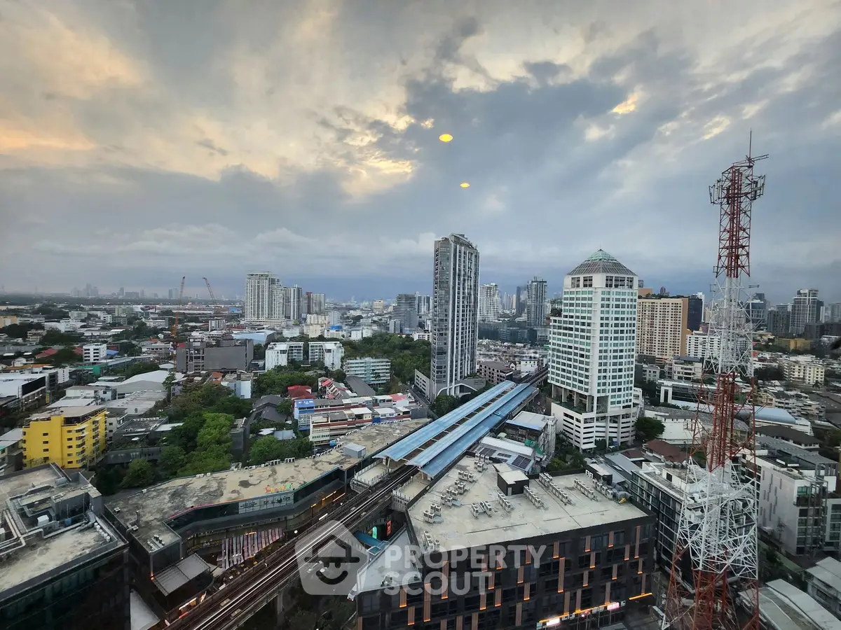 Stunning cityscape view showcasing urban skyline with high-rise buildings and lush greenery.