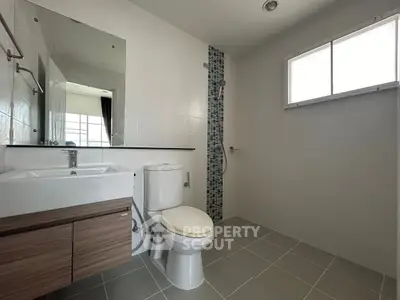 Modern bathroom with sleek fixtures and large window for natural light